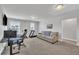 Spacious bonus room featuring a cozy sofa, desk area, and fitness equipment, perfect for recreation and relaxation at 175 Steep Rock Dr, Willow Springs, NC 27592