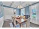 Dining area featuring a wooden table with seating for six, with elegant wainscoting and a decorative chandelier at 175 Steep Rock Dr, Willow Springs, NC 27592