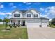 Charming two-story home with a three-car garage and a well-manicured lawn in a residential neighborhood at 175 Steep Rock Dr, Willow Springs, NC 27592