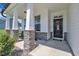Inviting front porch with stone accents, sturdy columns, and a charming decorative wreath on the front door at 175 Steep Rock Dr, Willow Springs, NC 27592
