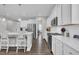 Bright, open kitchen with white cabinets, stainless steel appliances, and a large center island with seating at 175 Steep Rock Dr, Willow Springs, NC 27592