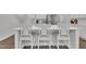 Bright kitchen features a large island with white cabinets, quartz countertops, and seating for three at 175 Steep Rock Dr, Willow Springs, NC 27592