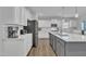 A well-equipped kitchen with stainless steel appliances, white cabinets, and a functional kitchen island at 175 Steep Rock Dr, Willow Springs, NC 27592