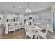 Spacious kitchen offers white cabinets, stainless steel appliances, a large island, and a cozy dining area at 175 Steep Rock Dr, Willow Springs, NC 27592