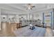 Open-concept living room with hardwood floors, plenty of natural light, and seamless access to the kitchen at 175 Steep Rock Dr, Willow Springs, NC 27592