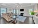 Inviting living room with a fireplace, hardwood floors, a ceiling fan, and ample natural light at 175 Steep Rock Dr, Willow Springs, NC 27592