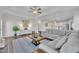 Bright and open living room featuring hardwood floors, a ceiling fan, comfortable seating, and ample natural light at 175 Steep Rock Dr, Willow Springs, NC 27592