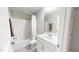 Bright bathroom features a shower-tub combo and a vanity with a large mirror at 1880 Woodall Crest Dr, Apex, NC 27502