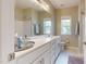 A bathroom features a white vanity, framed mirror, and a shower/tub combo at 1880 Woodall Crest Dr, Apex, NC 27502