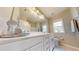 Bright bathroom featuring a large mirror, double vanity, and a shower/tub combo at 1880 Woodall Crest Dr, Apex, NC 27502