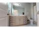 Bathroom featuring a large vanity with ample storage, a toilet, and shower with white tile, exuding cleanliness at 1880 Woodall Crest Dr, Apex, NC 27502
