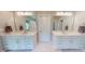 Bright bathroom with dual vanities, modern fixtures, and a neutral color palette at 1880 Woodall Crest Dr, Apex, NC 27502