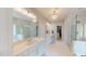 Bright bathroom featuring double sinks, a soaking tub, glass shower, and walk-in closet at 1880 Woodall Crest Dr, Apex, NC 27502