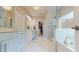 Bright bathroom with a double sink vanity, glass shower, soaking tub, and walk-in closet at 1880 Woodall Crest Dr, Apex, NC 27502