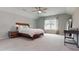 Spacious bedroom with a bed, ceiling fan, neutral carpeting, and lots of natural light at 1880 Woodall Crest Dr, Apex, NC 27502
