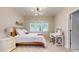 Bright bedroom with three windows, a full-sized bed with white bedding, and a modern light fixture at 1880 Woodall Crest Dr, Apex, NC 27502