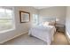 Well-lit bedroom with neutral walls, a bed, and two windows providing ample natural light at 1880 Woodall Crest Dr, Apex, NC 27502