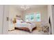 Bright bedroom with three windows, a full-sized bed with white bedding, and a modern light fixture at 1880 Woodall Crest Dr, Apex, NC 27502