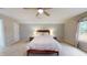 Vaulted bedroom with a bed, ceiling fan, neutral carpeting, and lots of natural light at 1880 Woodall Crest Dr, Apex, NC 27502
