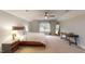 Bedroom with vaulted ceiling, a bed, ceiling fan, neutral carpeting, and lots of natural light at 1880 Woodall Crest Dr, Apex, NC 27502