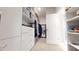 A walk-in closet with custom storage solutions and a carpeted floor at 1880 Woodall Crest Dr, Apex, NC 27502