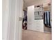 A walk-in closet is outfitted with custom storage solutions and a carpeted floor at 1880 Woodall Crest Dr, Apex, NC 27502