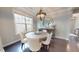 Dining area with chandelier lighting, a buffet, a round table, natural light, and hardwood floors at 1880 Woodall Crest Dr, Apex, NC 27502