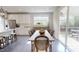 Open dining room with stylish chairs, wood floors, and natural light, perfect for Gathering meals and entertaining guests at 1880 Woodall Crest Dr, Apex, NC 27502