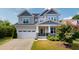 Well-manicured two-story home with attached garage and inviting front porch at 1880 Woodall Crest Dr, Apex, NC 27502