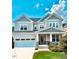 Beautiful two-story home with manicured lawn, attached garage and inviting front porch at 1880 Woodall Crest Dr, Apex, NC 27502