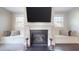 A cozy fireplace with built-in benches, hardwood floors, natural light, and decorative accessories at 1880 Woodall Crest Dr, Apex, NC 27502
