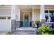 Charming front porch with stone accents and a blue door at 1880 Woodall Crest Dr, Apex, NC 27502