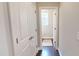 Bright hallway with access to the powder room, hardwood floors, and bright white trim at 1880 Woodall Crest Dr, Apex, NC 27502