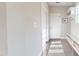 Neat hallway with a storage bench and coat hooks, providing organization and a welcoming entry to the home at 1880 Woodall Crest Dr, Apex, NC 27502