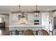 Modern kitchen with a large island, stainless steel appliances, and pendant lighting, blending style and functionality at 1880 Woodall Crest Dr, Apex, NC 27502