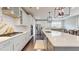Modern kitchen featuring white cabinetry, stainless steel appliances, and a large island with seating at 1880 Woodall Crest Dr, Apex, NC 27502