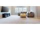 Comfortable living room with plush seating, a TV, and neutral tones, creating a relaxing and enjoyable entertainment space at 1880 Woodall Crest Dr, Apex, NC 27502