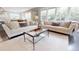 Bright living room with neutral furniture, a glass coffee table, hardwood floors, and natural light at 1880 Woodall Crest Dr, Apex, NC 27502