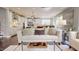 Open living space with view to kitchen, with white sofa and glass coffee table at 1880 Woodall Crest Dr, Apex, NC 27502