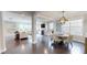Open concept dining and living room featuring hardwood floors, natural light, and modern decor at 1880 Woodall Crest Dr, Apex, NC 27502