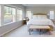 Spacious main bedroom with large windows, neutral walls, and a decorative light fixture at 1880 Woodall Crest Dr, Apex, NC 27502