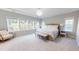 Spacious main bedroom with large windows, neutral walls, and a decorative light fixture at 1880 Woodall Crest Dr, Apex, NC 27502