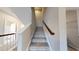 A carpeted staircase with a wood railing leads to the upper level at 1880 Woodall Crest Dr, Apex, NC 27502