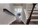 Elegant staircase with wooden steps and white railings, offering a stylish transition between the home's levels at 1880 Woodall Crest Dr, Apex, NC 27502