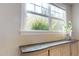 Sunlit window showcasing lush green outdoor views, enhancing the room's ambiance with natural light and a serene atmosphere at 1880 Woodall Crest Dr, Apex, NC 27502