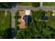 Birds eye view of a new home with a black metal roof and surrounding foliage at 205 Gentry St, Roxboro, NC 27573