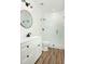 Modern bathroom with a glass shower, round mirror and white vanity at 205 Gentry St, Roxboro, NC 27573
