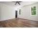 Bright room featuring wood flooring, windows and a ceiling fan at 205 Gentry St, Roxboro, NC 27573