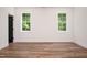 Light bedroom showcasing two windows and wood flooring at 205 Gentry St, Roxboro, NC 27573