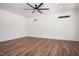 A well lit bedroom features wood flooring, a ceiling fan, and two bright windows at 205 Gentry St, Roxboro, NC 27573